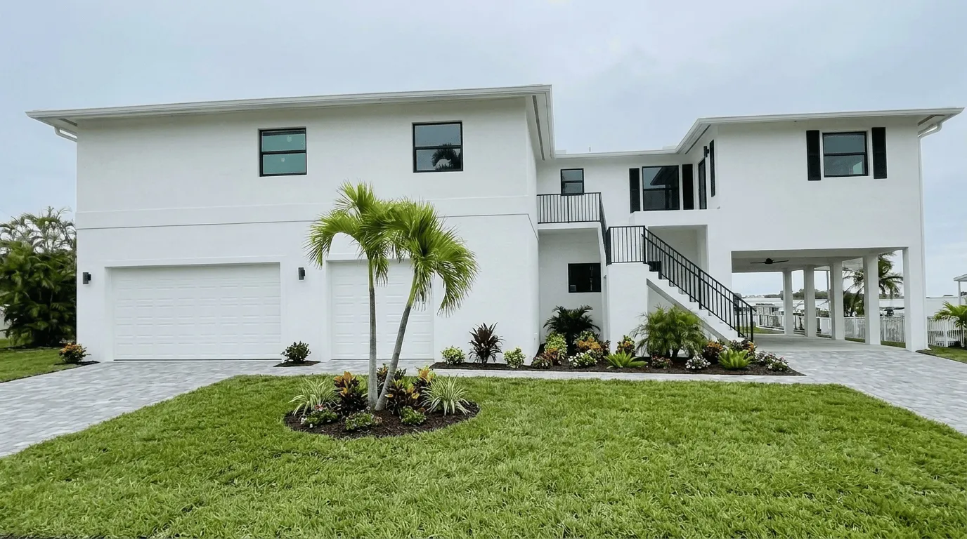 Two-story white home exterior with new landscaping