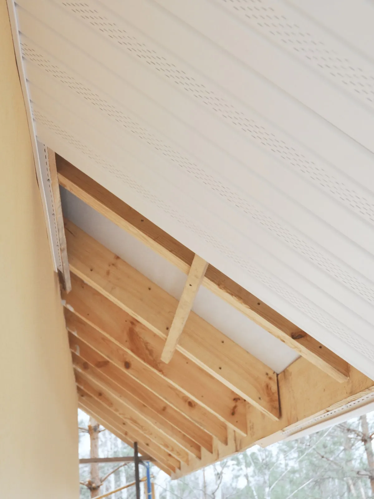 Soffit installation over exposed roof framing