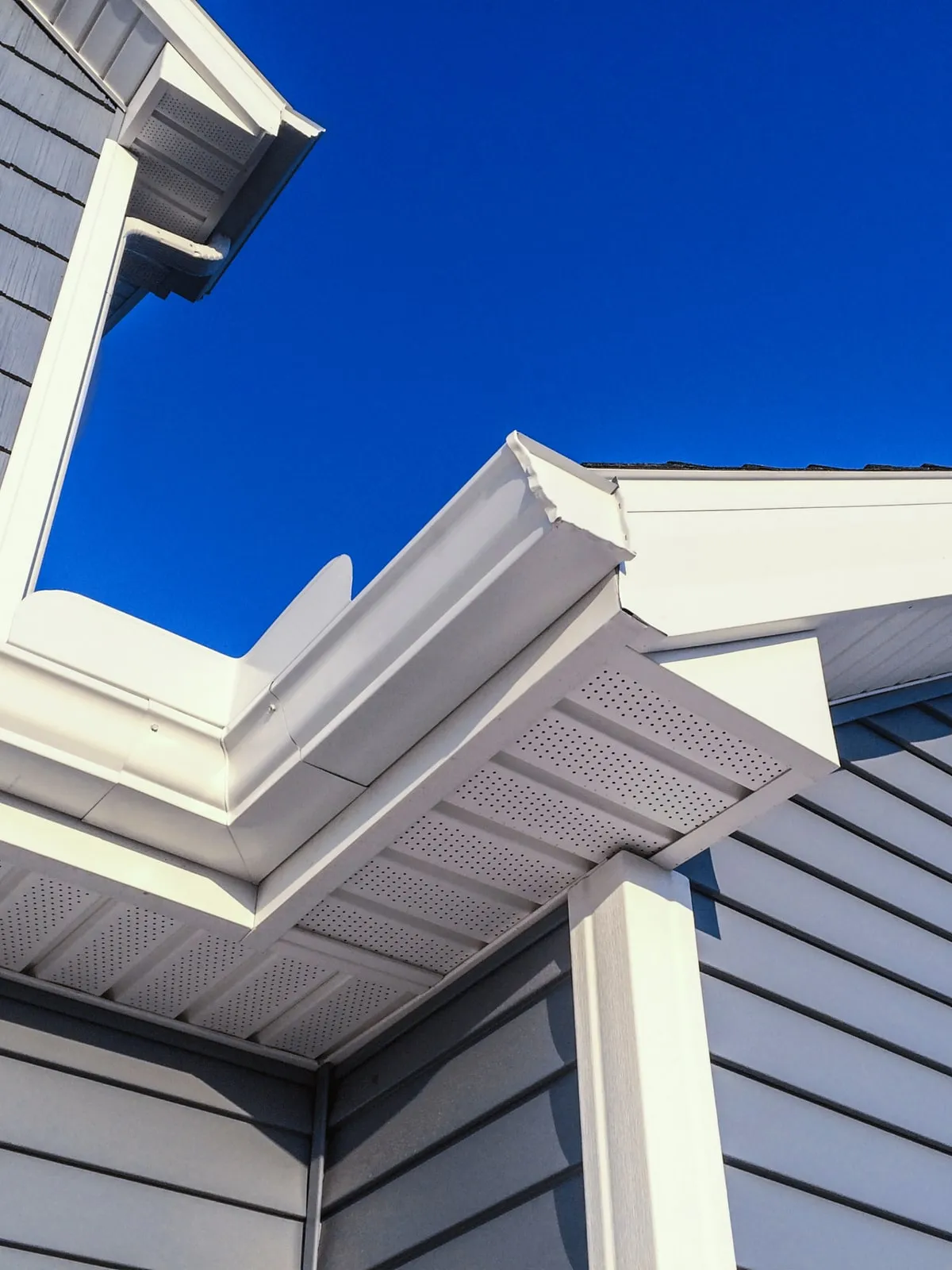 New fascia, soffit and gutters on a gray sided home