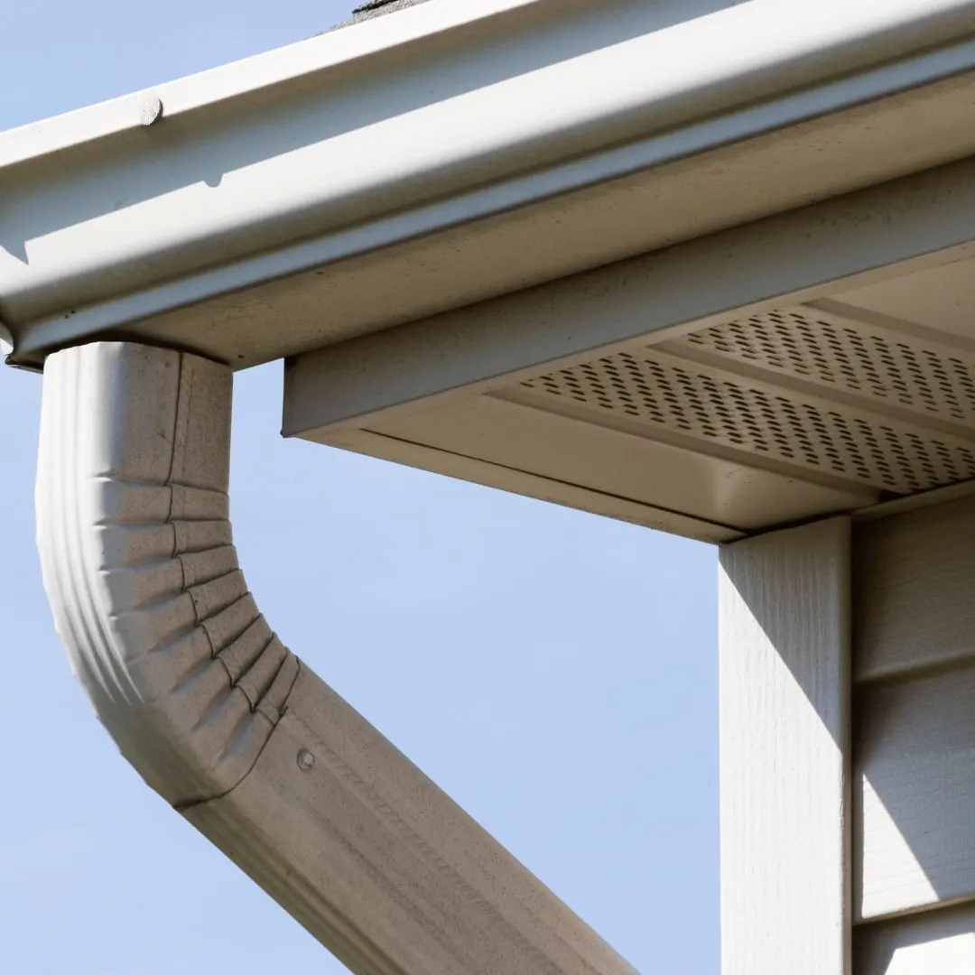 Downspout elbow and vented soffit on a new installation