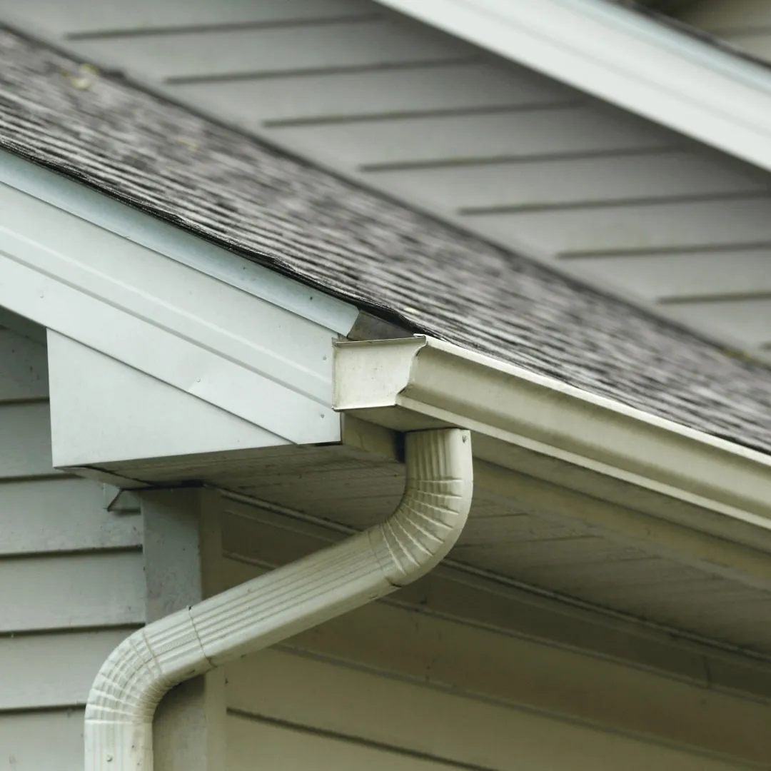 Gutter and downspout installed on a sided home