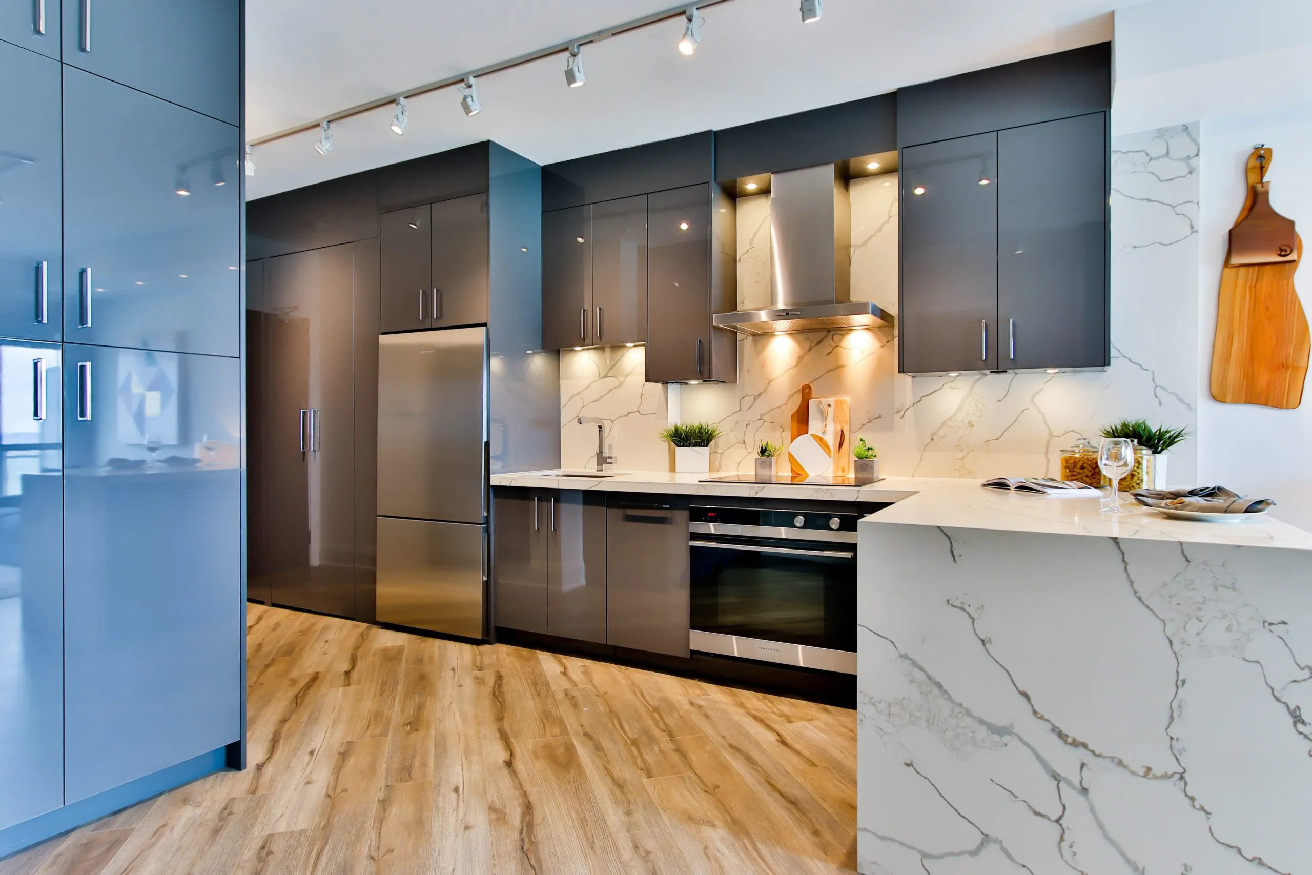 Modern kitchen with glossy cabinets and marble waterfall island