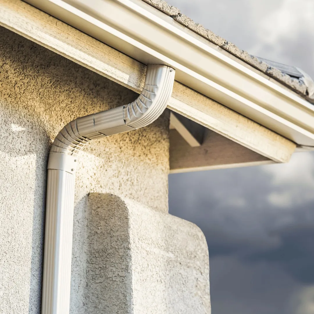 Seamless gutter and downspout on a stucco column