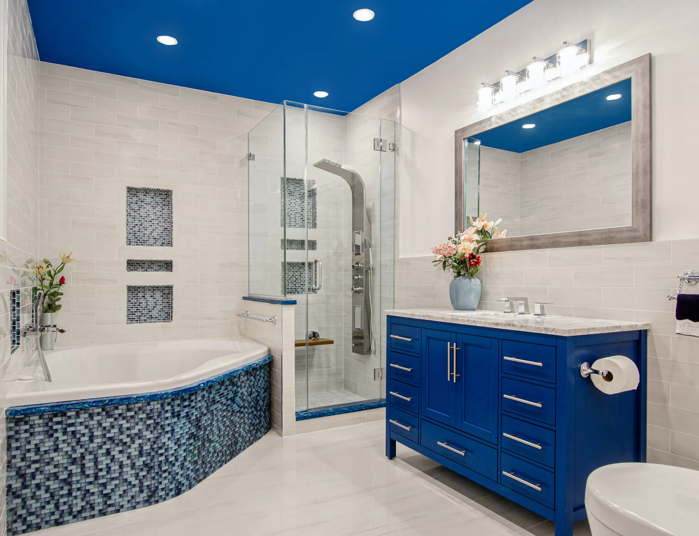 Bathroom remodel with blue mosaic tub and blue vanity