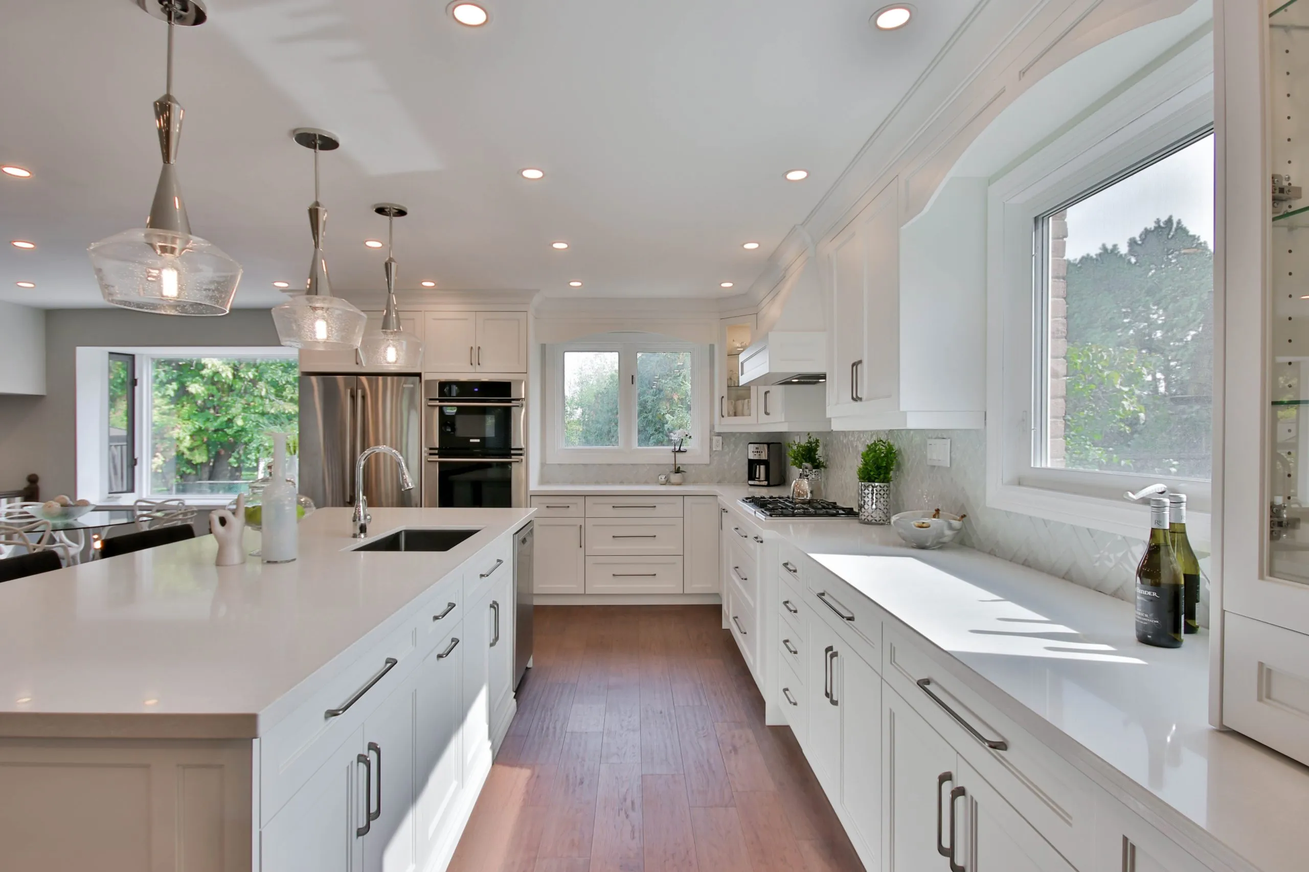 White kitchen with farmhouse sink and wood floors