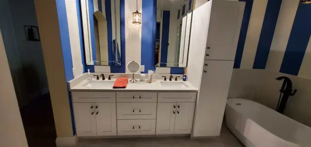 Bathroom remodel with white double vanity and new fixtures