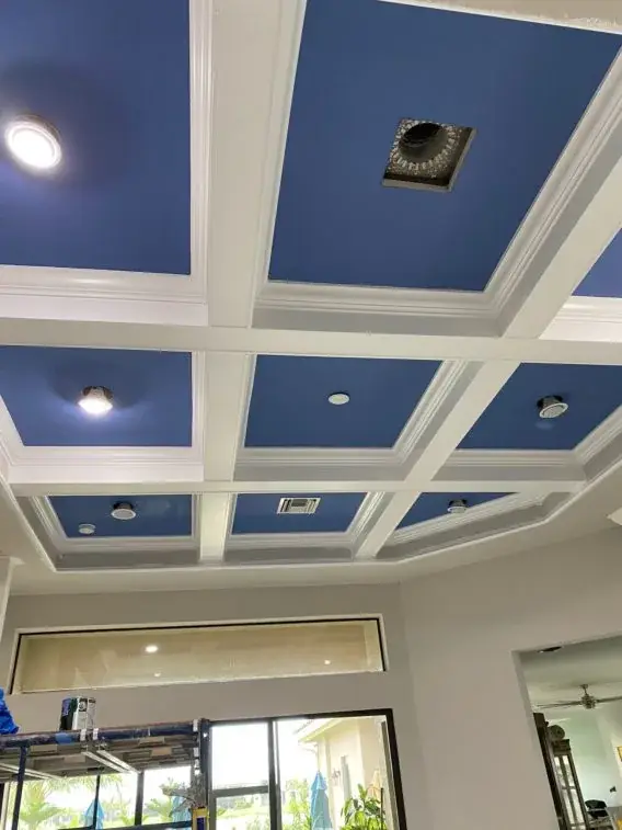 Finished coffered ceiling with recessed lighting and painted panels