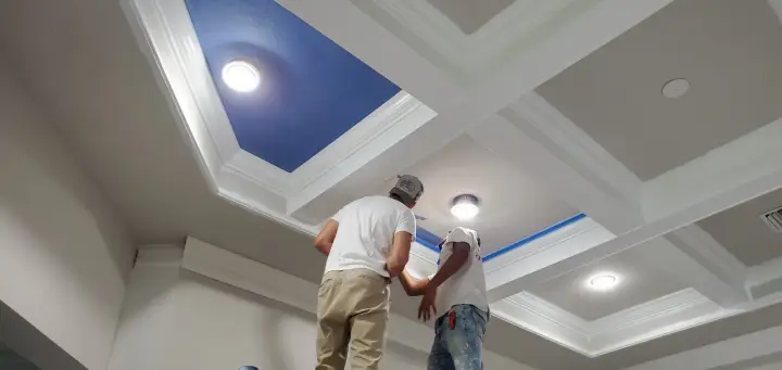 Excell carpenters finishing a coffered ceiling with blue panels