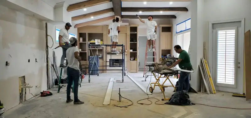 Excell carpenters installing trim and molding in a home
