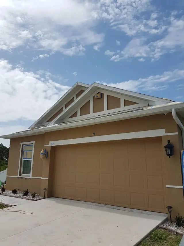 Home exterior with painted gable, fascia and garage door