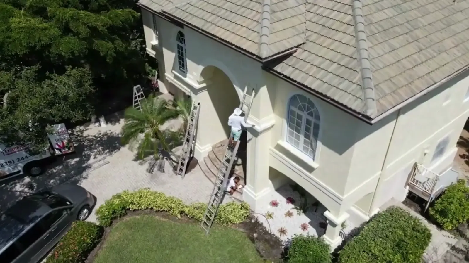 Excell crew painting a stucco home — still from the Excell film