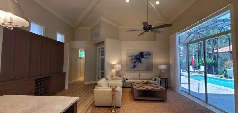 Renovated open living room with vaulted ceiling and new flooring