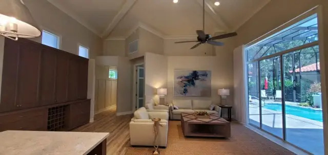 Renovated open living room with vaulted ceiling and new flooring
