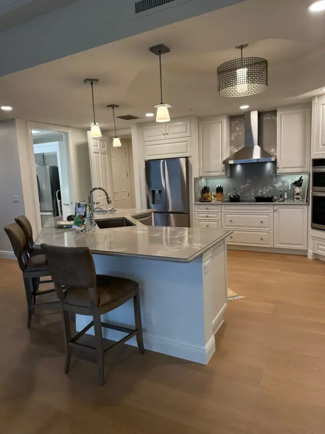Remodeled kitchen with quartz island and stainless appliances in Southwest Florida